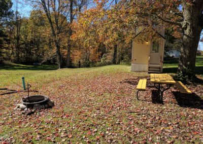 New River Tiny House hotel fire ring and picnic table