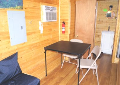 New River Tiny House hotel first floor of tiny house with table & chairs