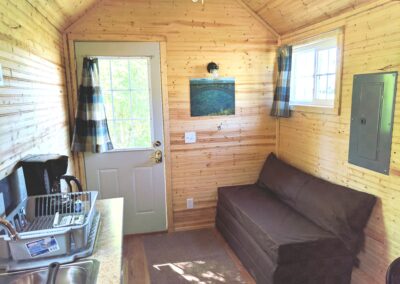 New River Tiny House hotel first floor of tiny house couch turns into bed